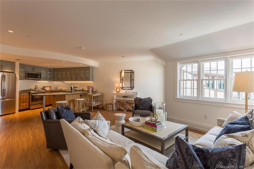 a living room with furniture window and wooden floor