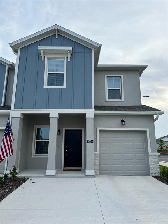 a front view of a house with garage