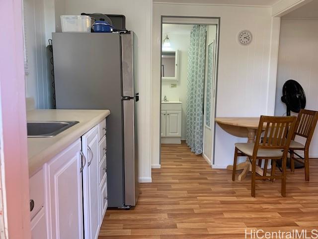 a kitchen with a table chairs refrigerator and cabinets