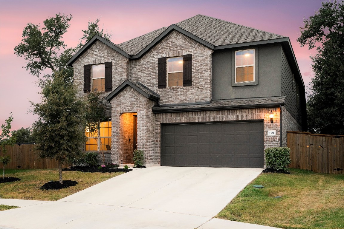 a front view of a house with a yard and garage