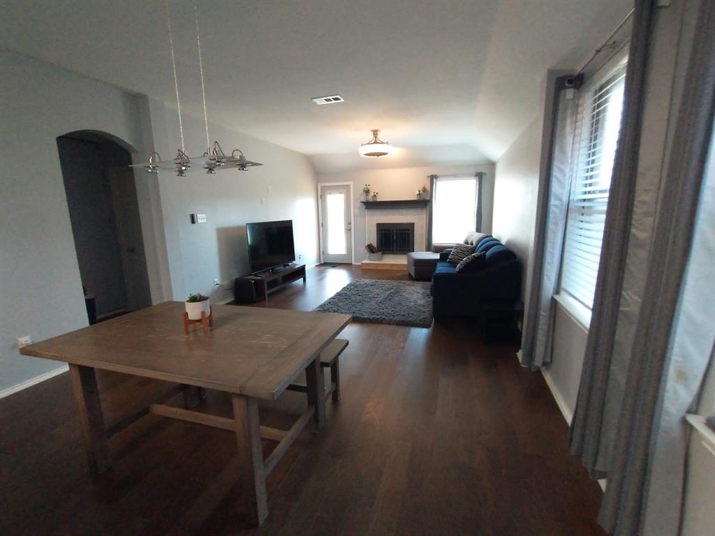 a view of a dining room with furniture and a flat screen tv