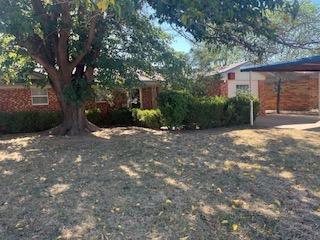 a view of a house with a tree in the background