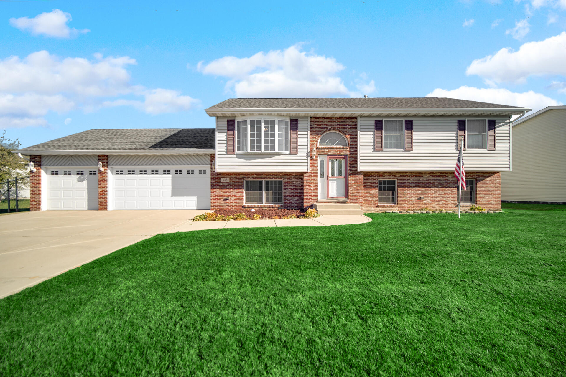 a view of a house with a yard and sitting area