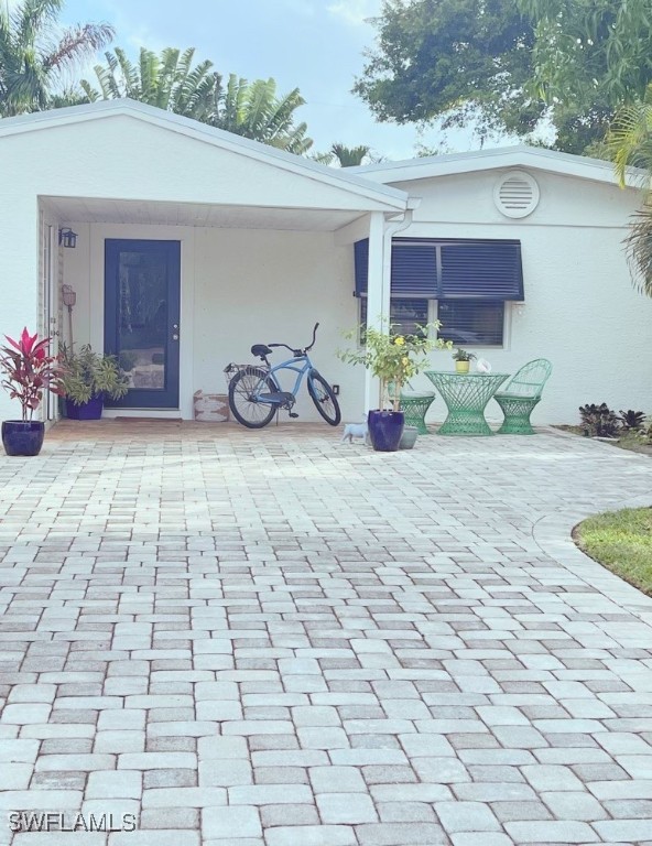 a view of a garage with a table and chairs in patio