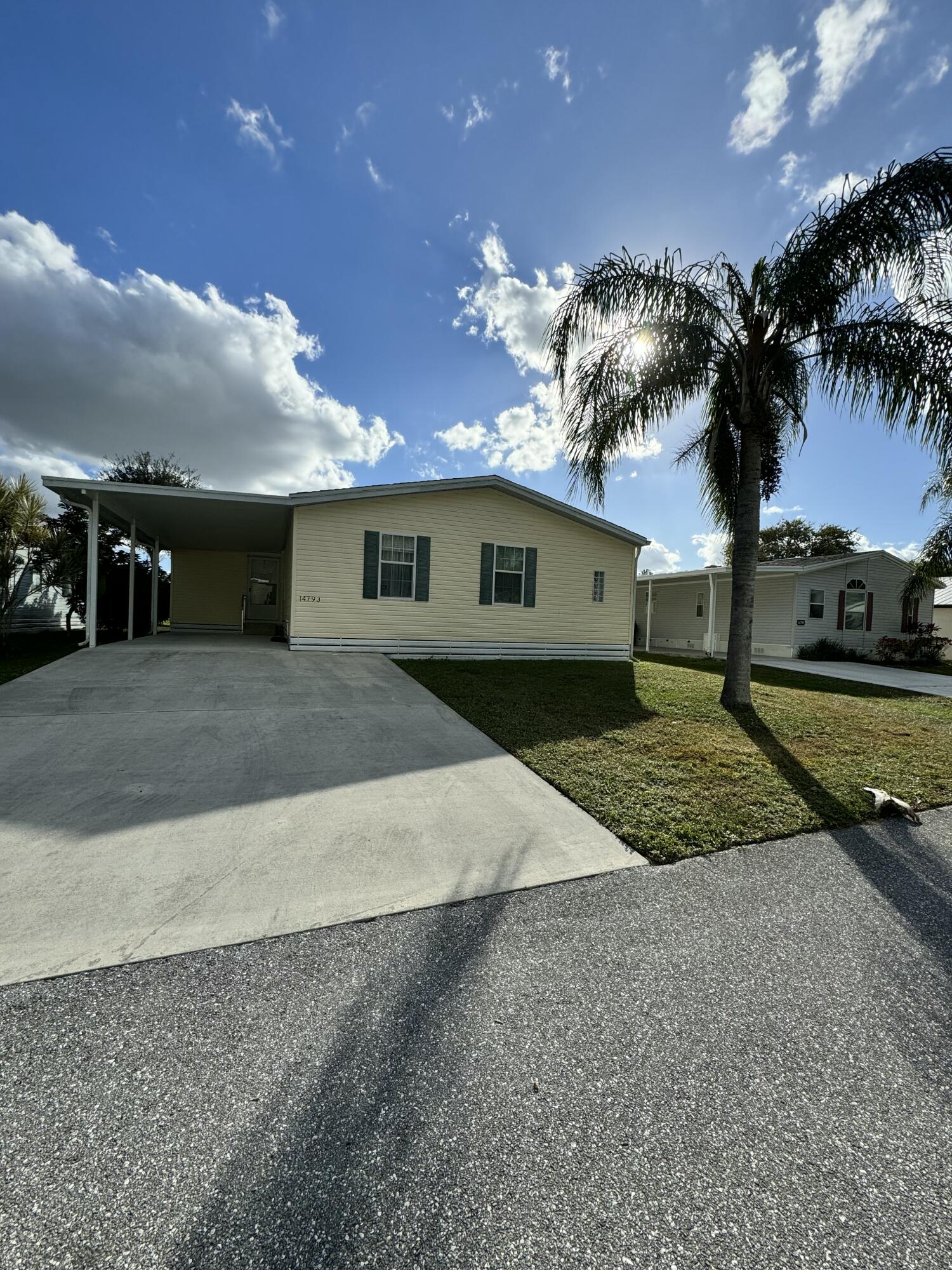 a view of a house with a yard and garage