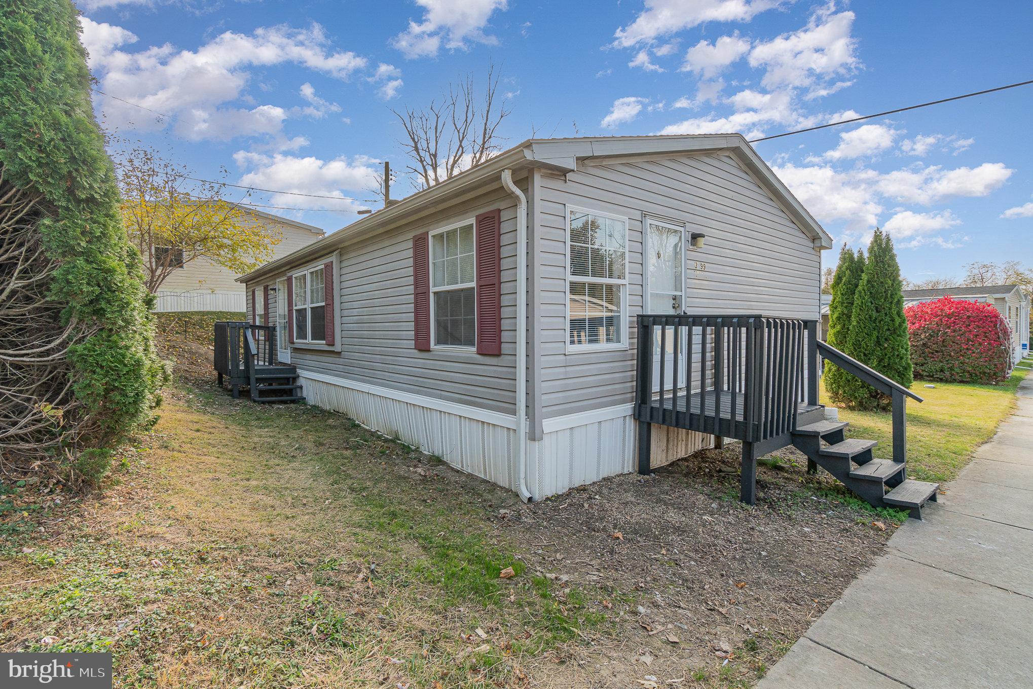 a view of a house with a yard and wooden fence