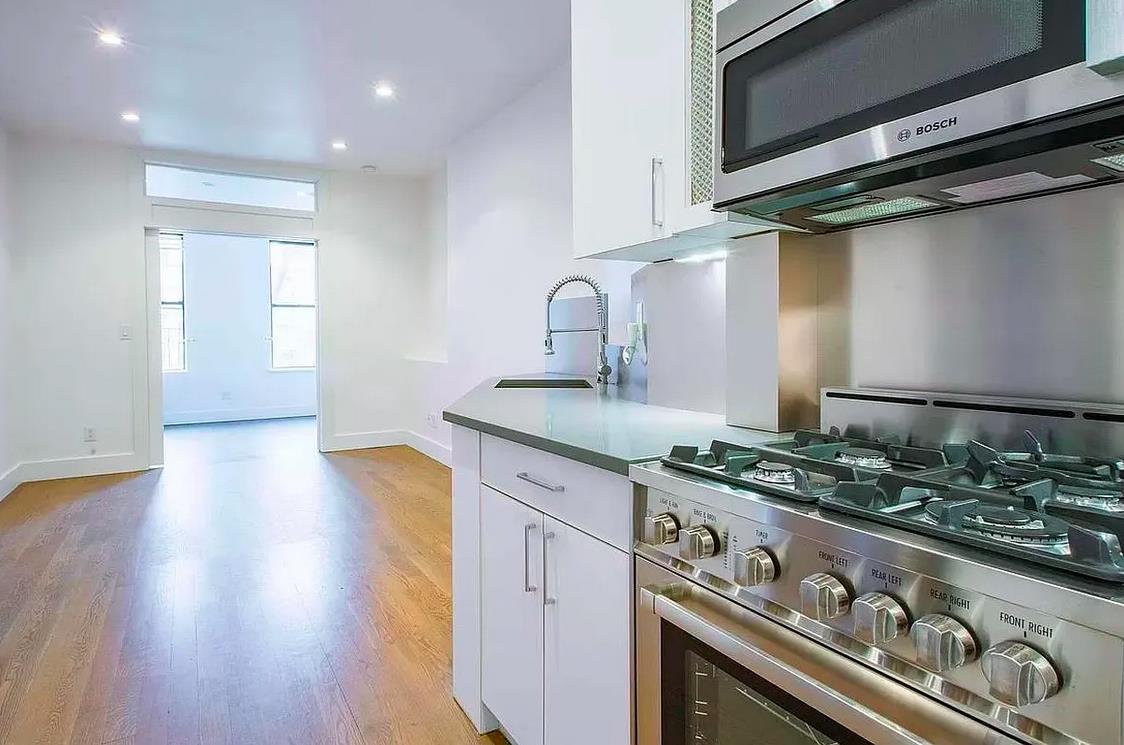 a kitchen with stainless steel appliances granite countertop a stove and a sink