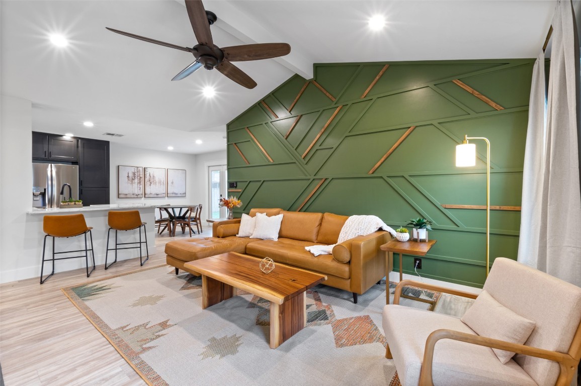 a living room with furniture a table and a potted plant