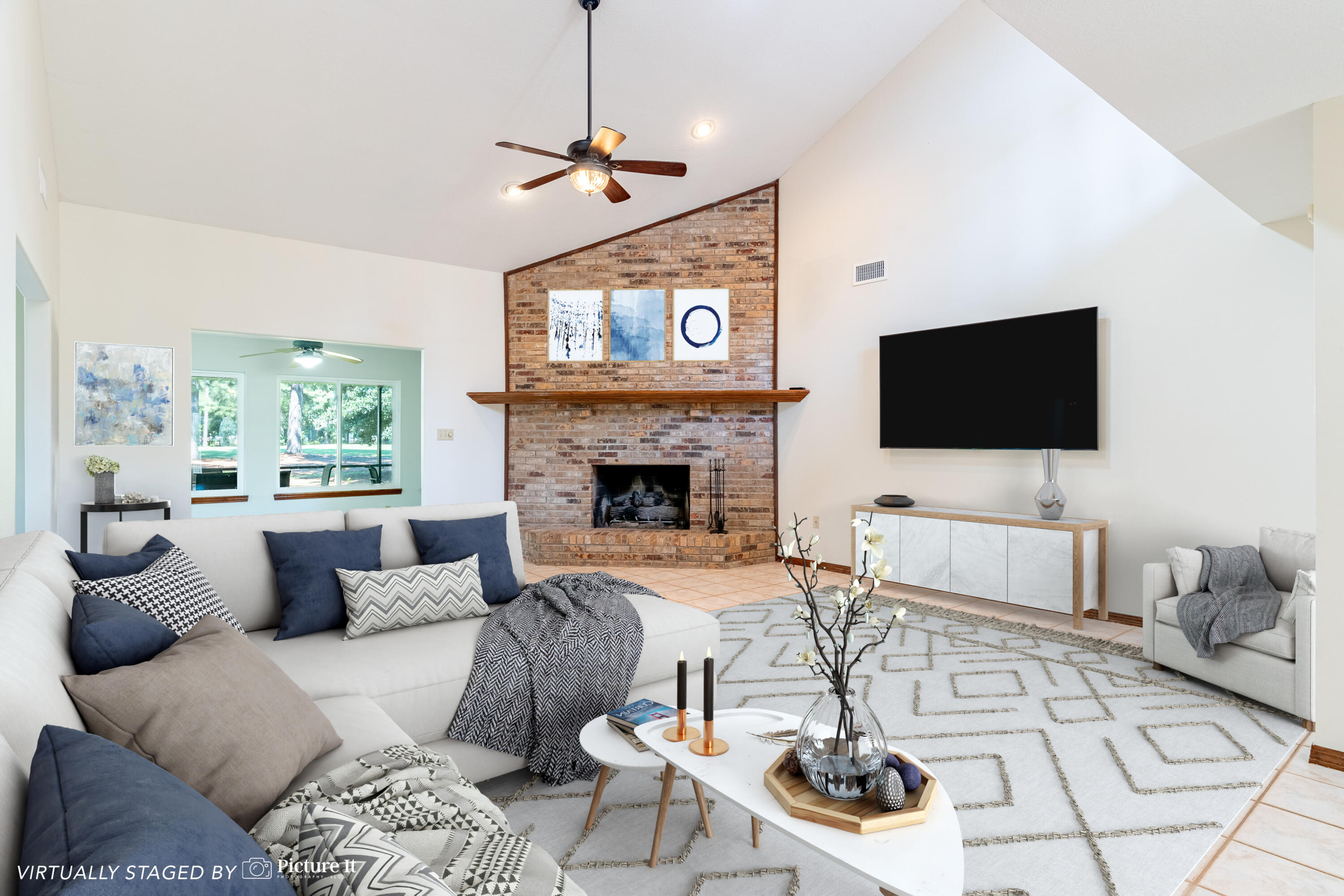 a living room with furniture a flat screen tv and a fireplace