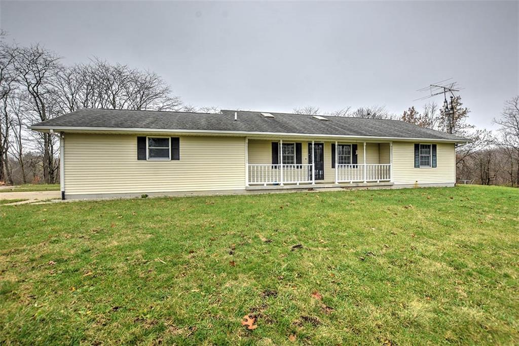 a front view of house with yard and green space