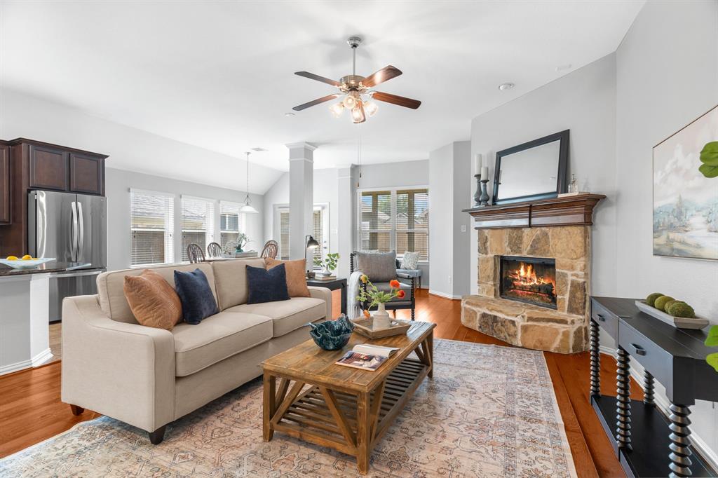 a living room with furniture a fireplace and a flat screen tv