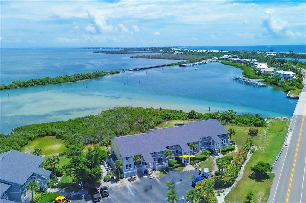 an aerial view of a houses with a lake