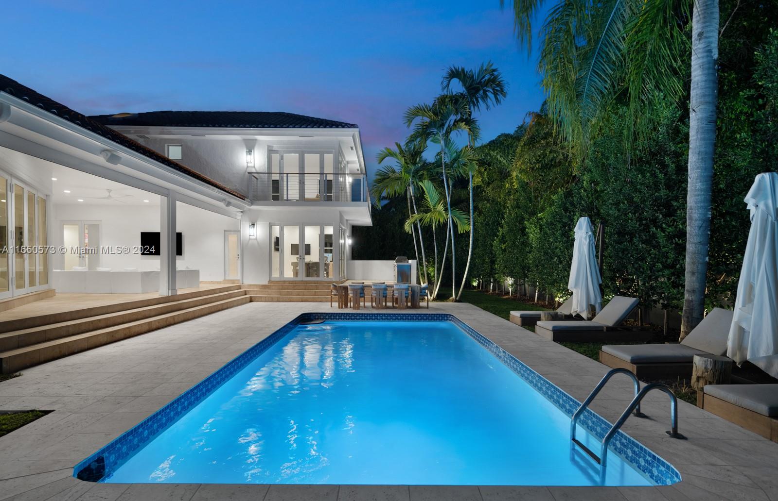 a swimming pool with outdoor seating and yard