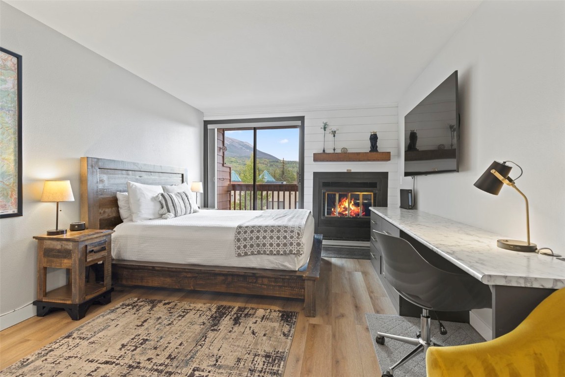 Bedroom space with wood burning fireplace.