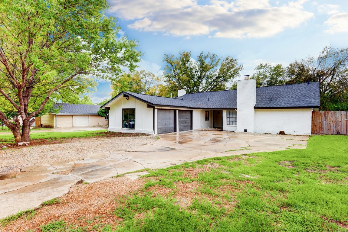 a front view of house with yard and trees