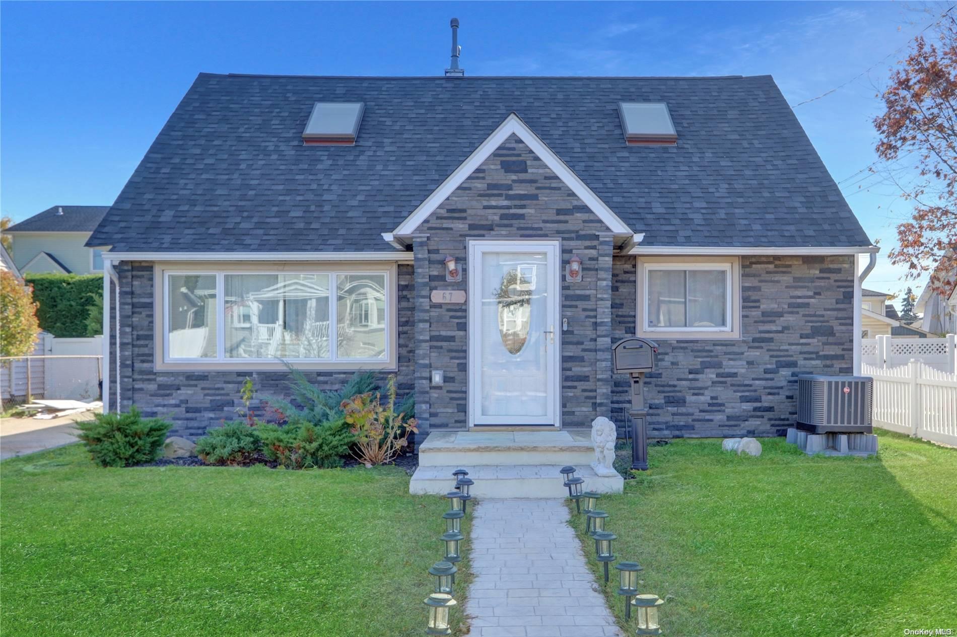 a front view of a house with a garden