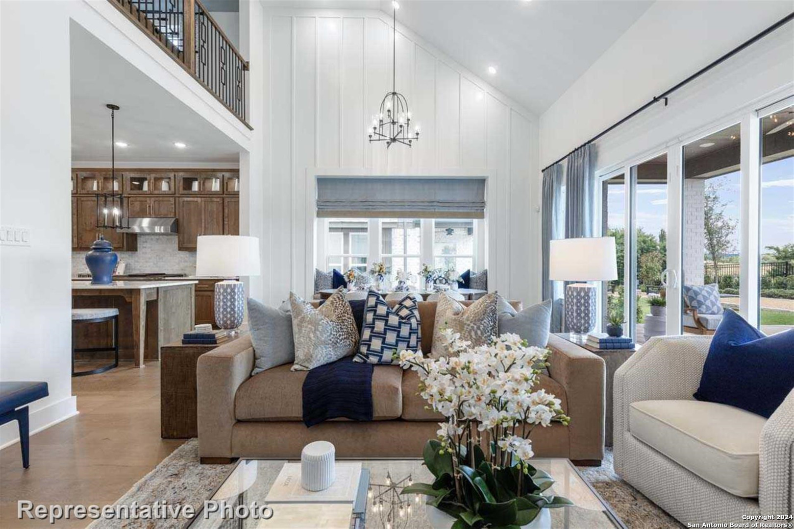 a living room with furniture large window and a chandelier