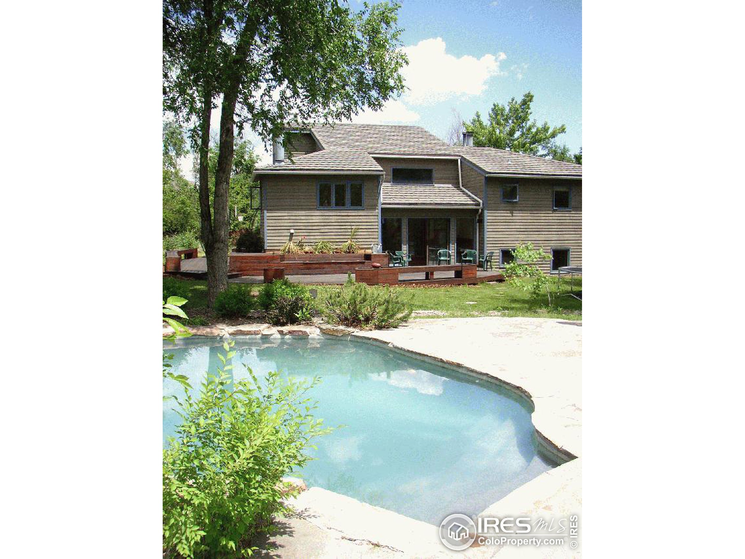 a view of a house with a yard patio and furniture