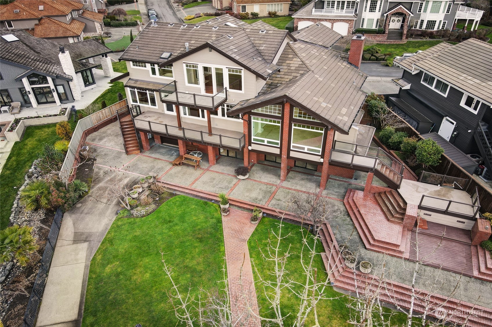 an aerial view of a house with a yard table and chairs