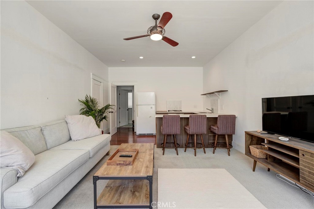 a living room with furniture a rug and a flat screen tv