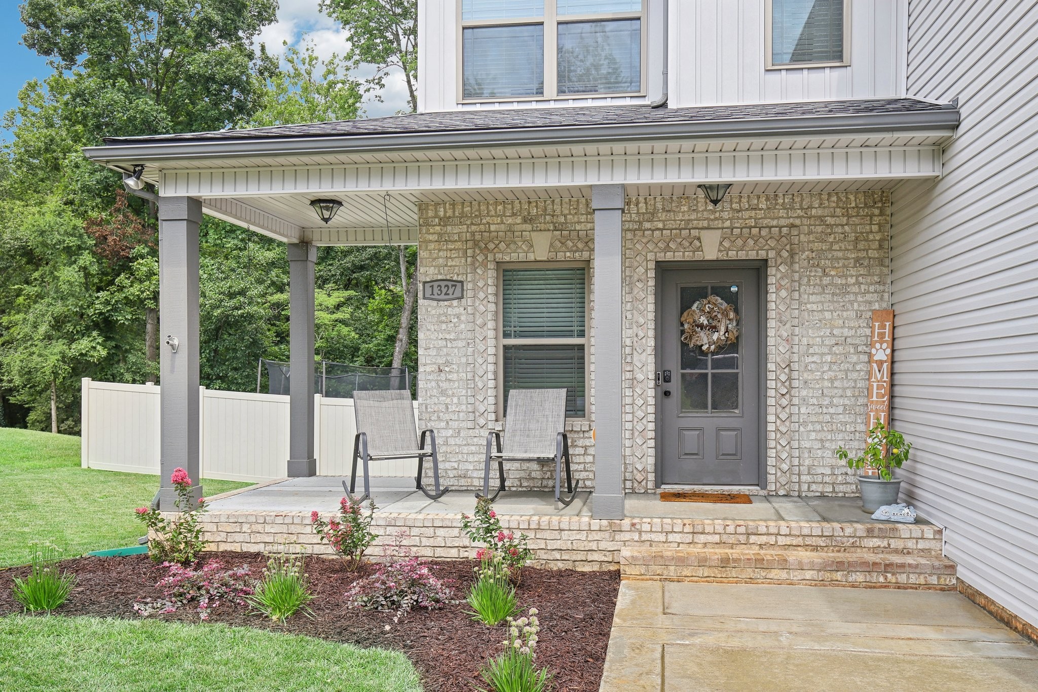 a front view of a house with garden