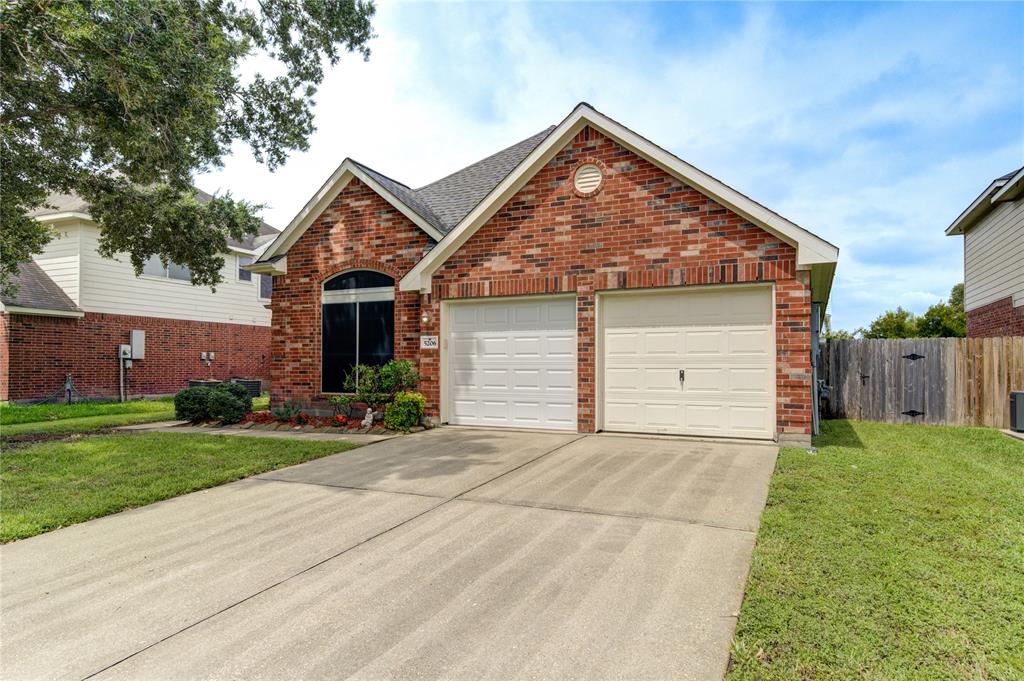 a front view of house with yard and garage