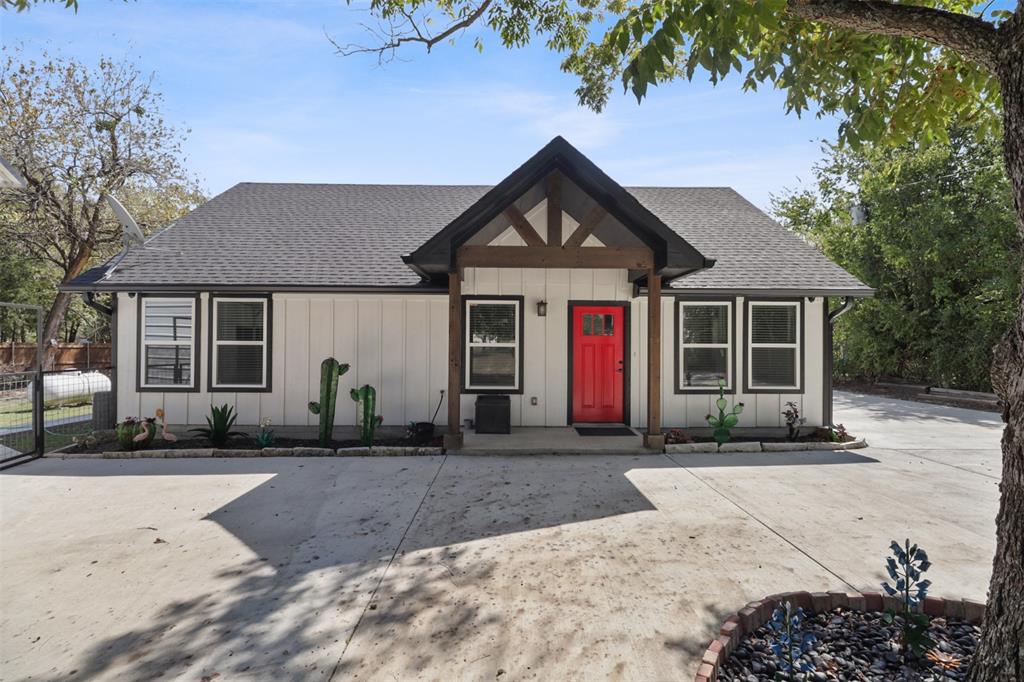 a front view of a house with a yard and outdoor seating