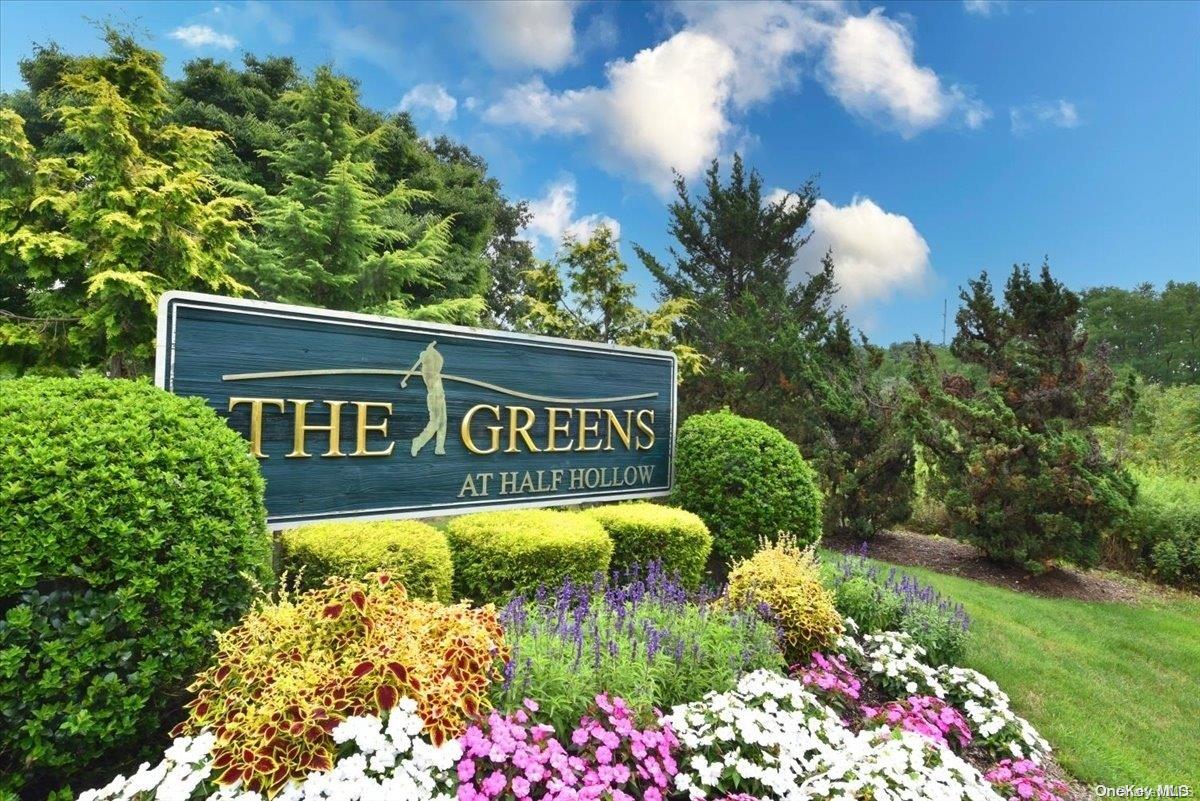 a view of sign board with flower around