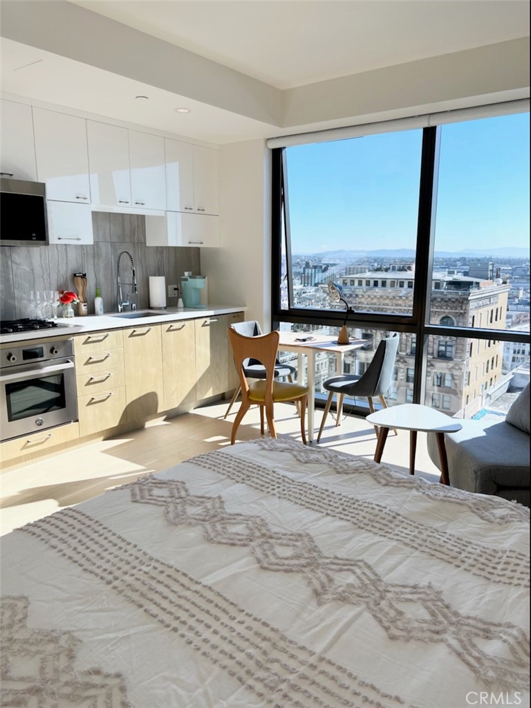 a living room with a large window and furniture