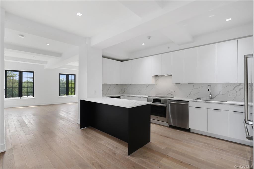 a kitchen with stainless steel appliances granite countertop a stove and a sink