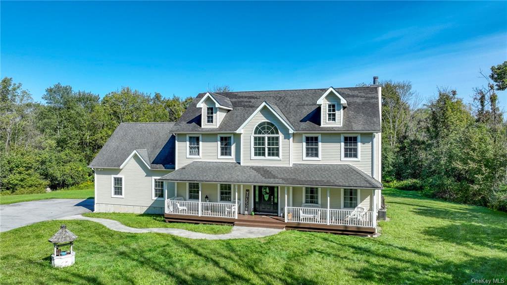 View of front of property with a porch and a front lawn