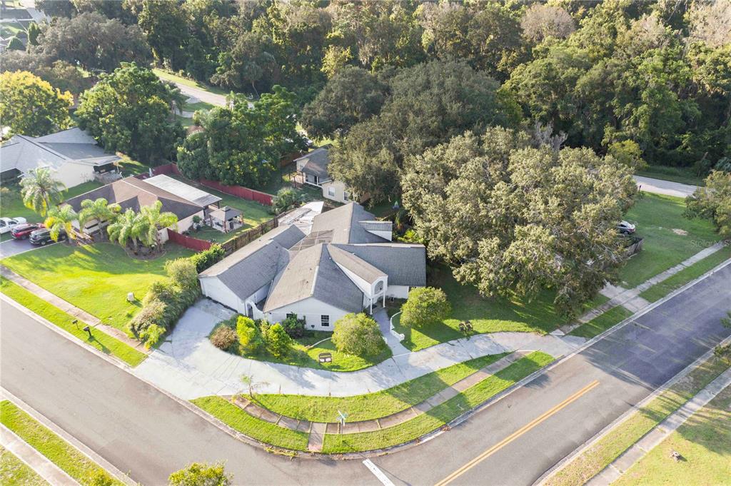 an aerial view of a house with a yard basket ball court and outdoor seating