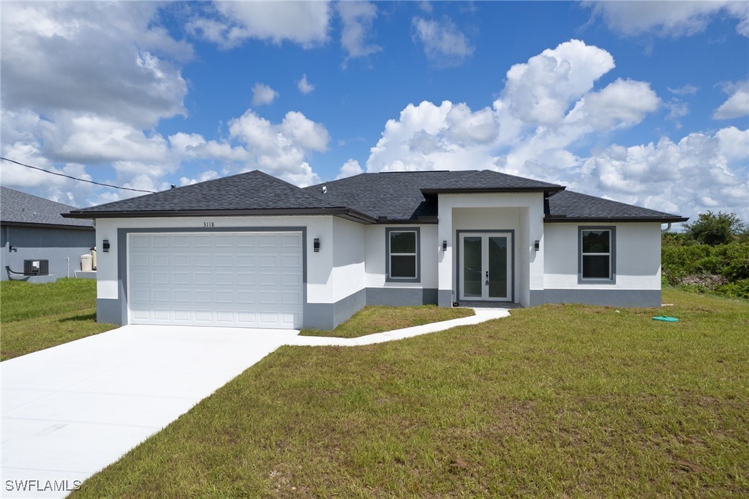 a front view of a house with a yard and garage