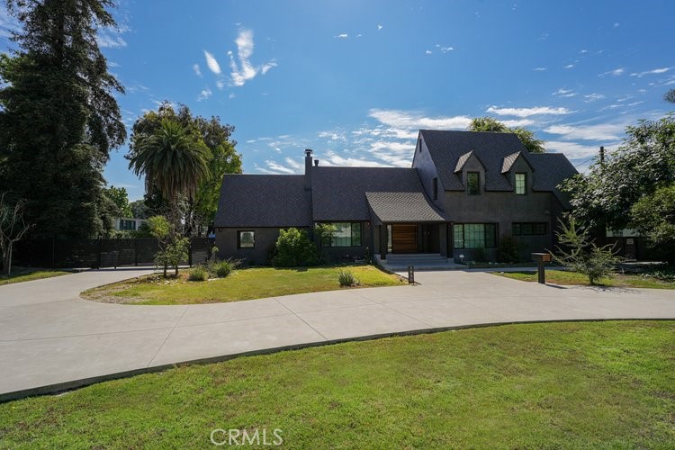 a view of a house with pool and a yard