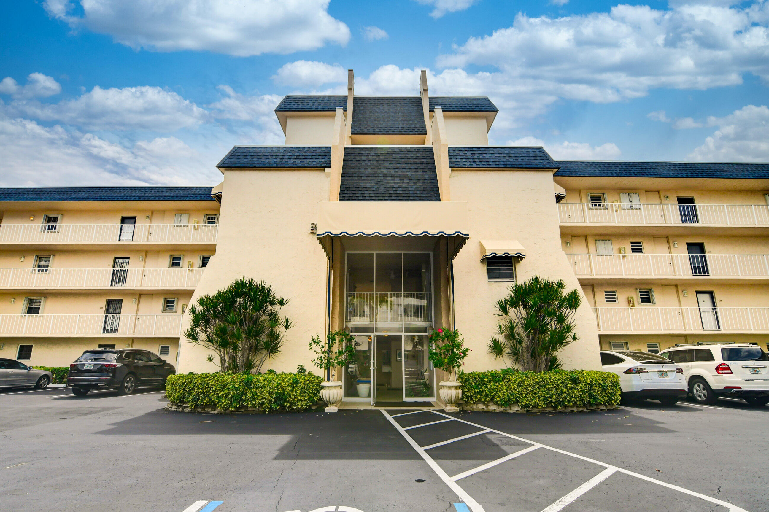 front view of a building with potted plants