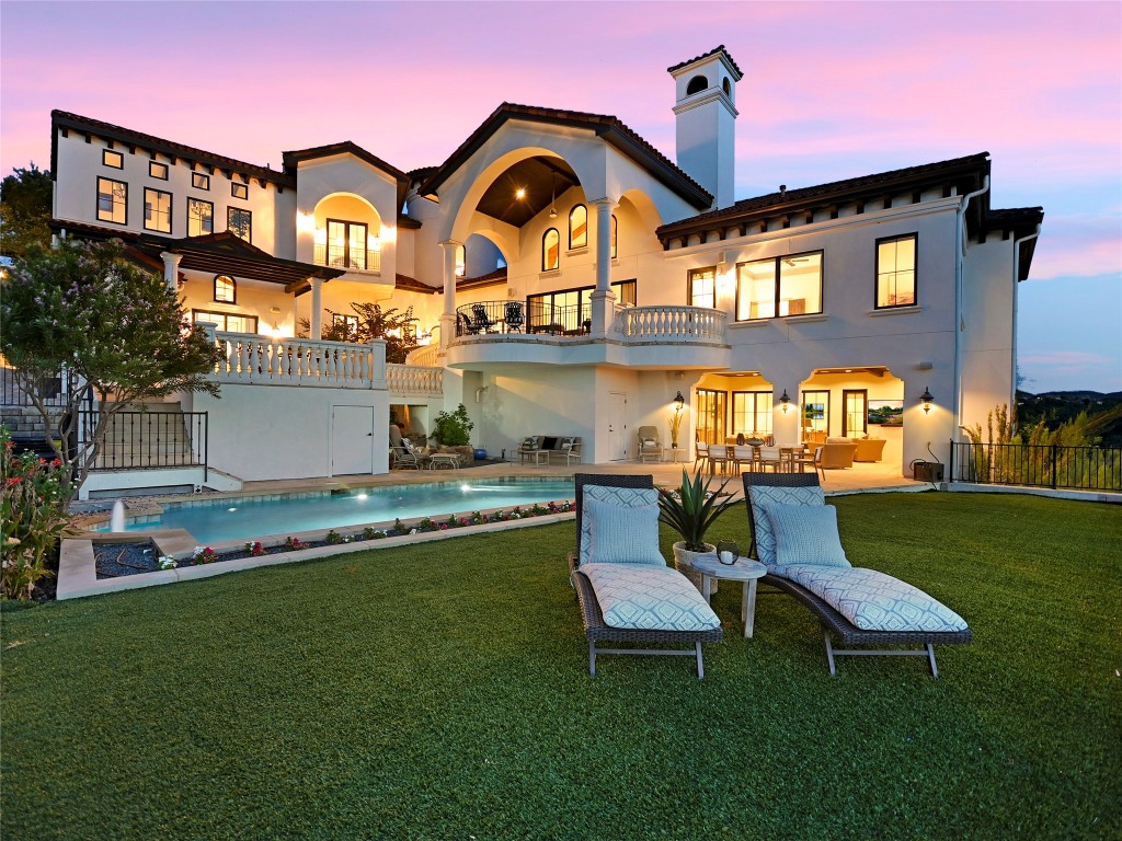 a front view of a house with swimming pool yard and outdoor seating