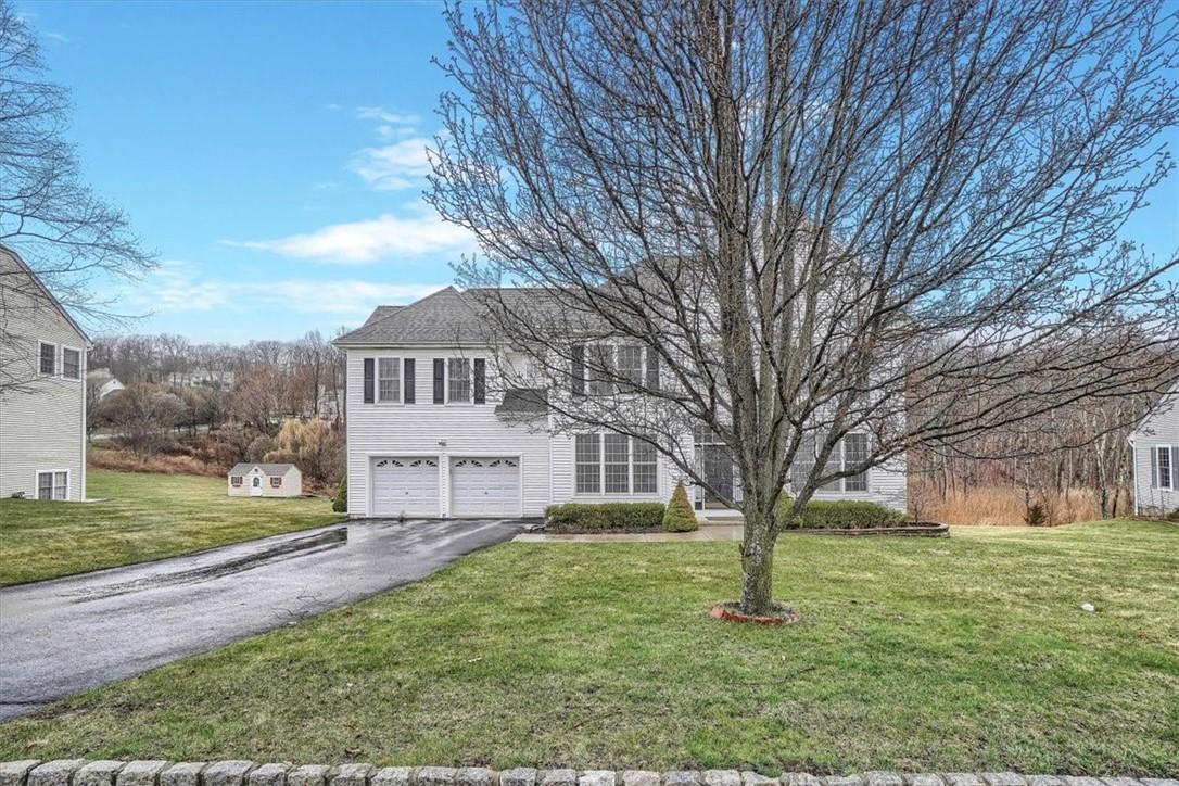 View of front of property with a garage and a front yard