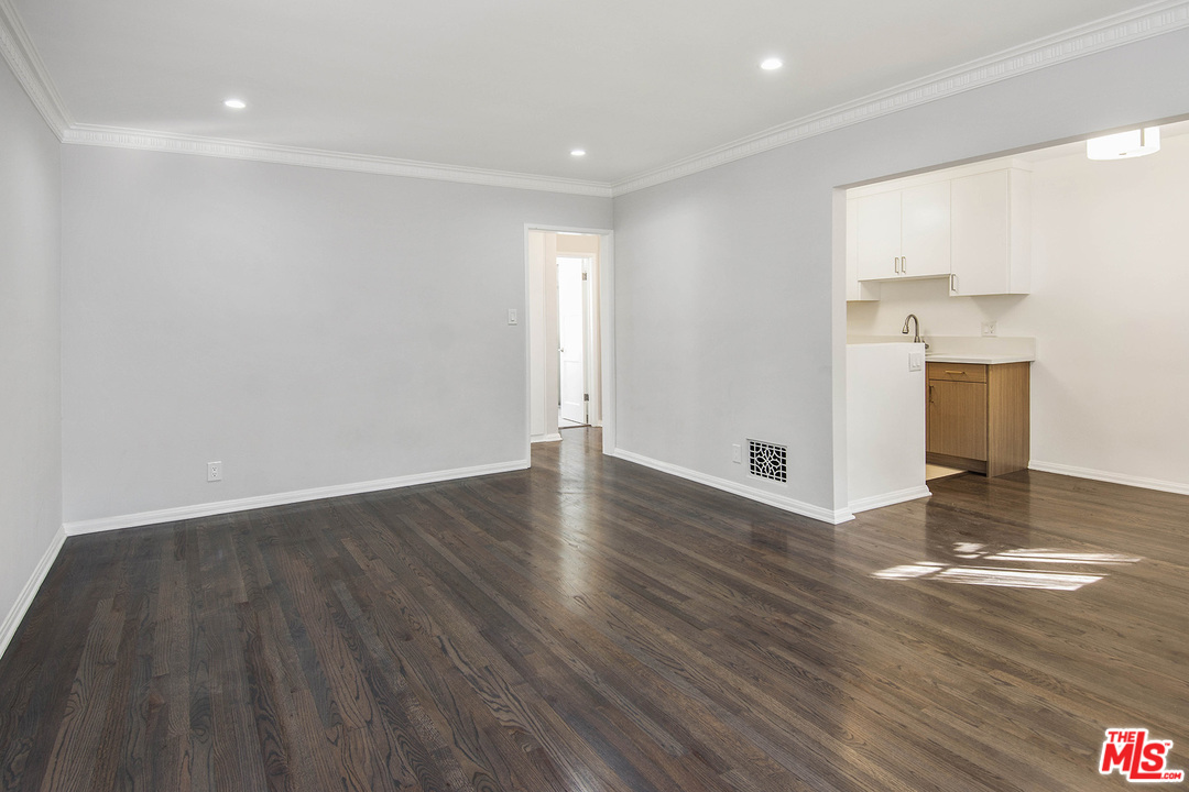 a view of a kitchen with wooden floor and a sink