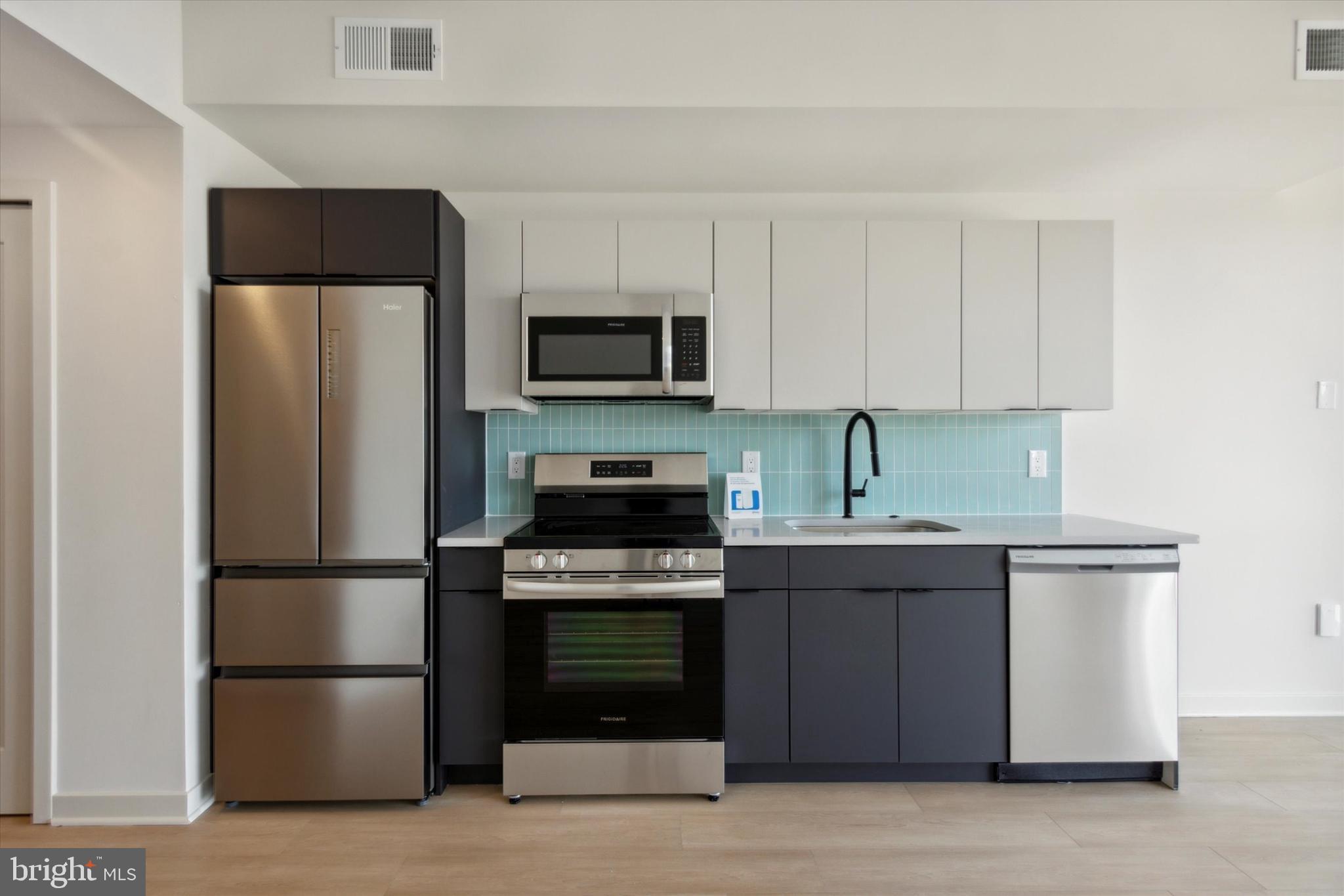 a kitchen with a sink and steel stainless steel appliances