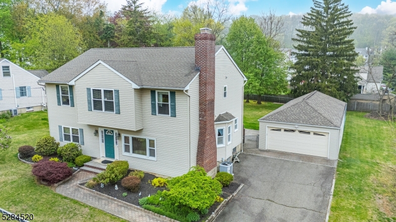 a aerial view of a house with a yard and potted plants