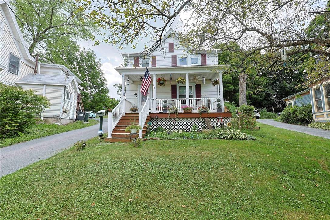 a view of a house with a yard porch and sitting area