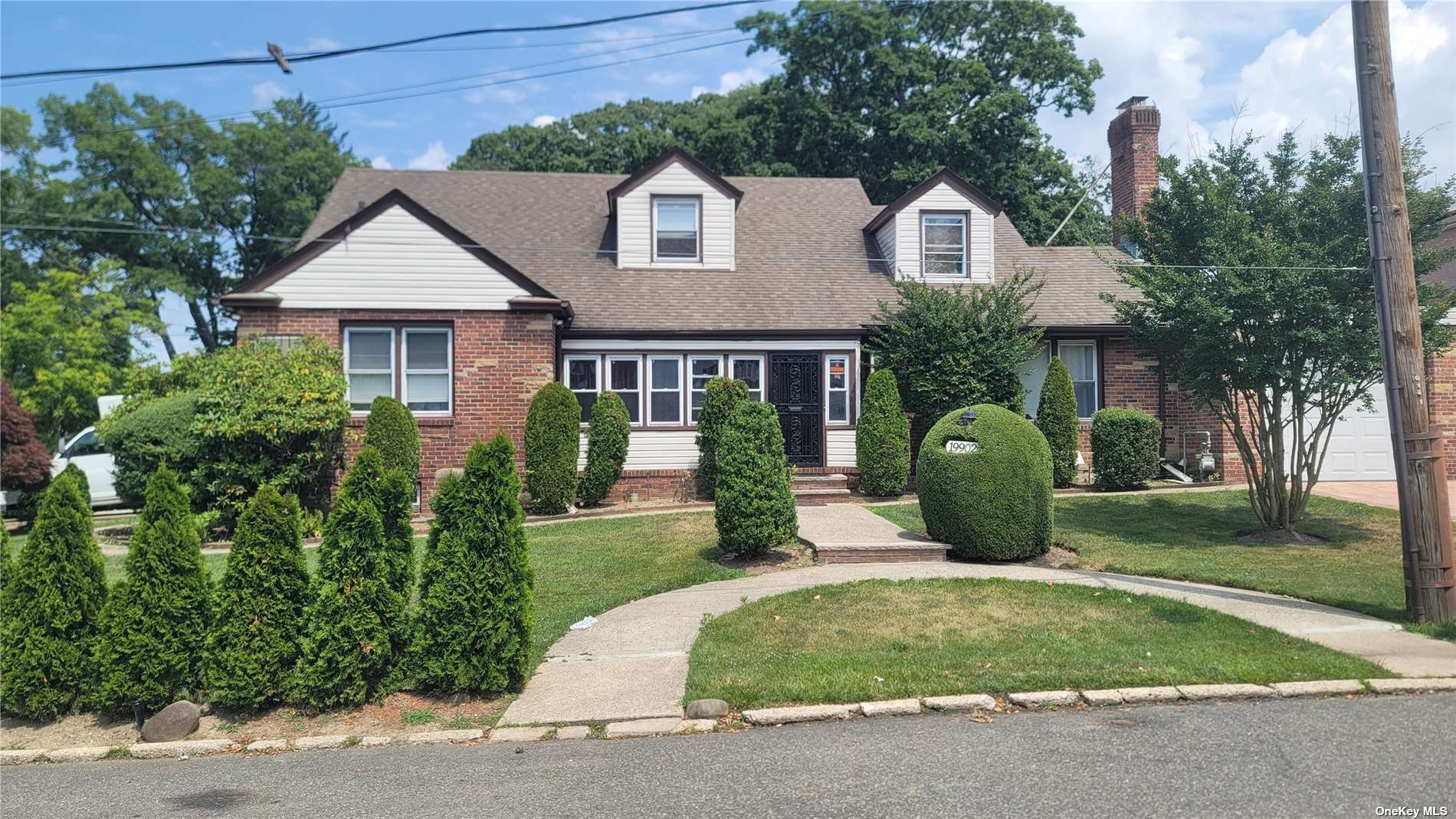 a front view of a house with a garden