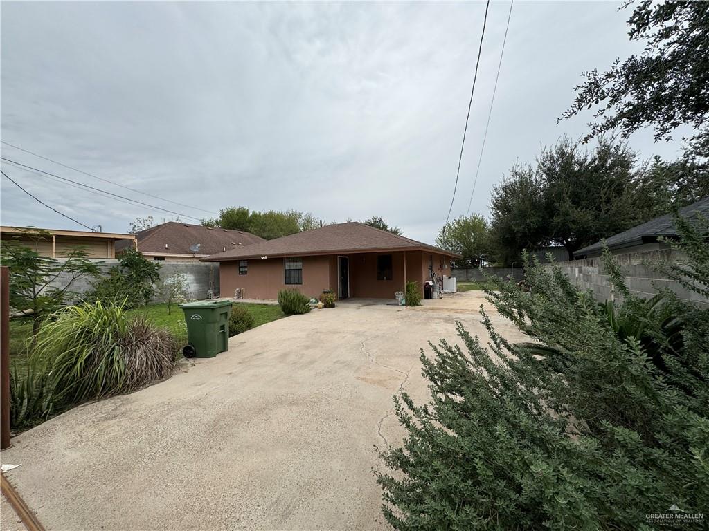 a view of house with yard and outdoor seating