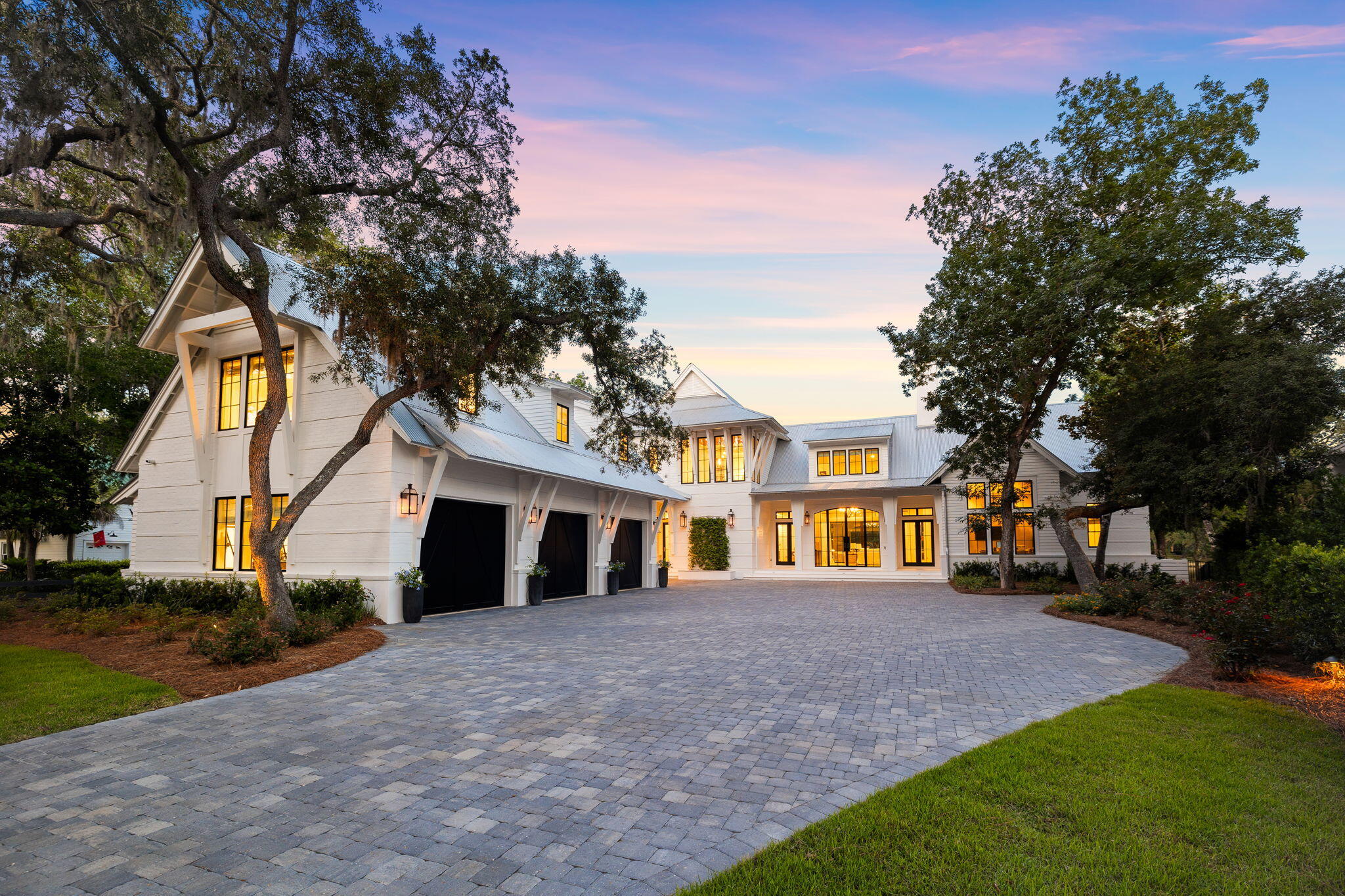 a front view of a house with a yard and trees