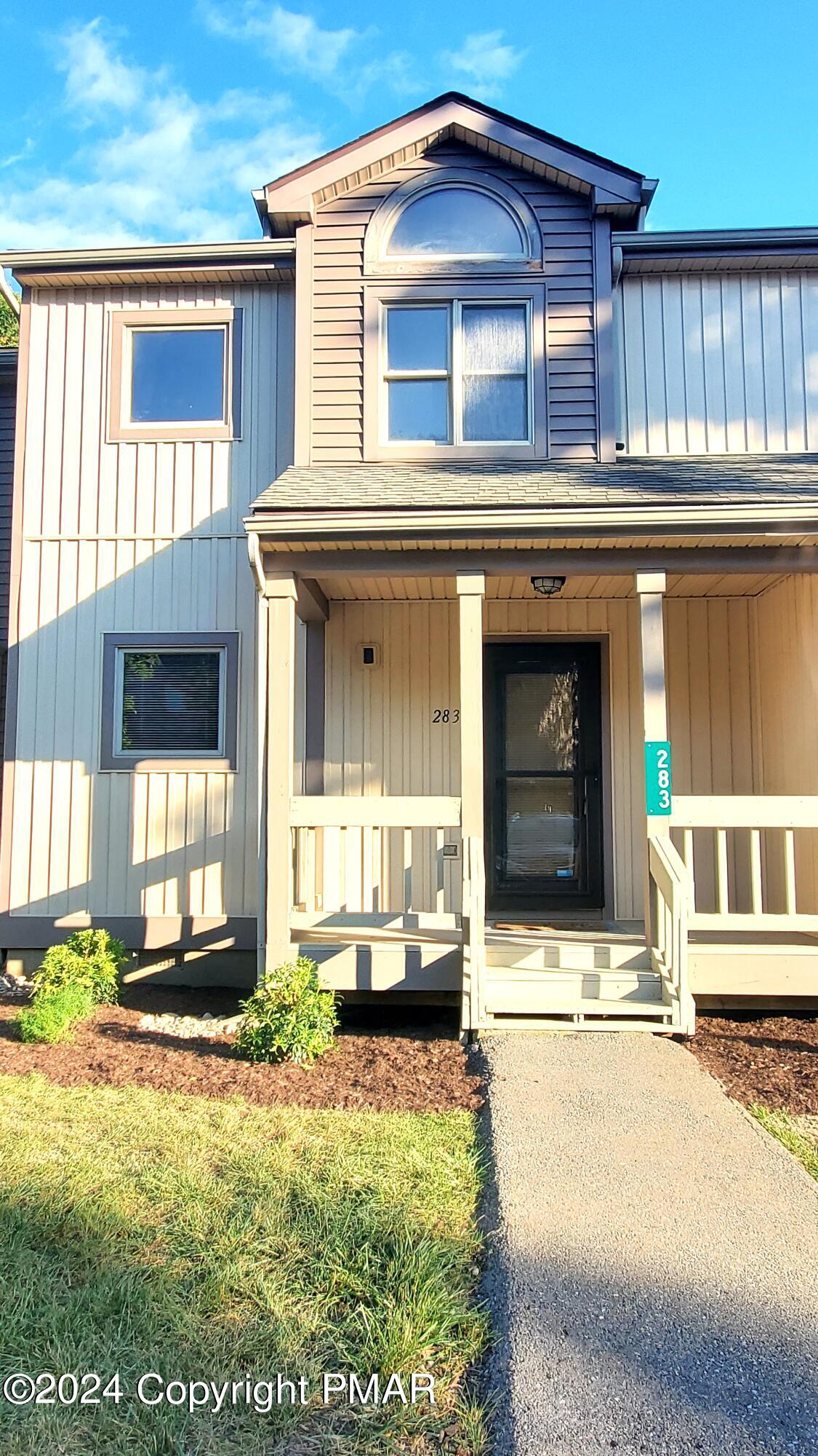 a front view of a house with a yard