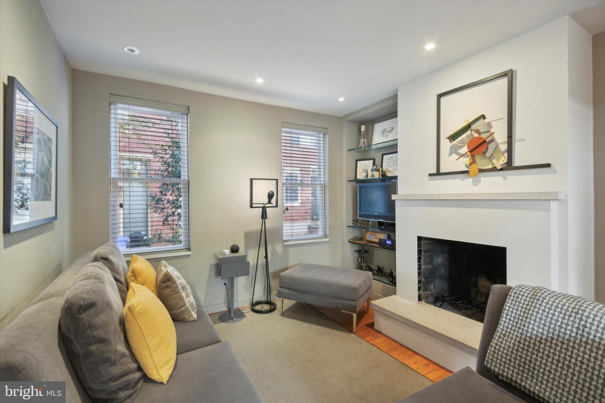 a living room with furniture and a fireplace