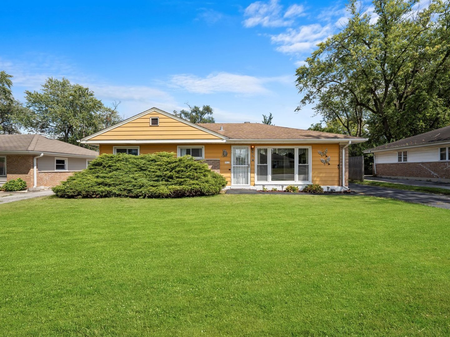 a front view of a house with a garden