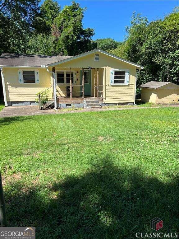 a front view of house with yard and green space