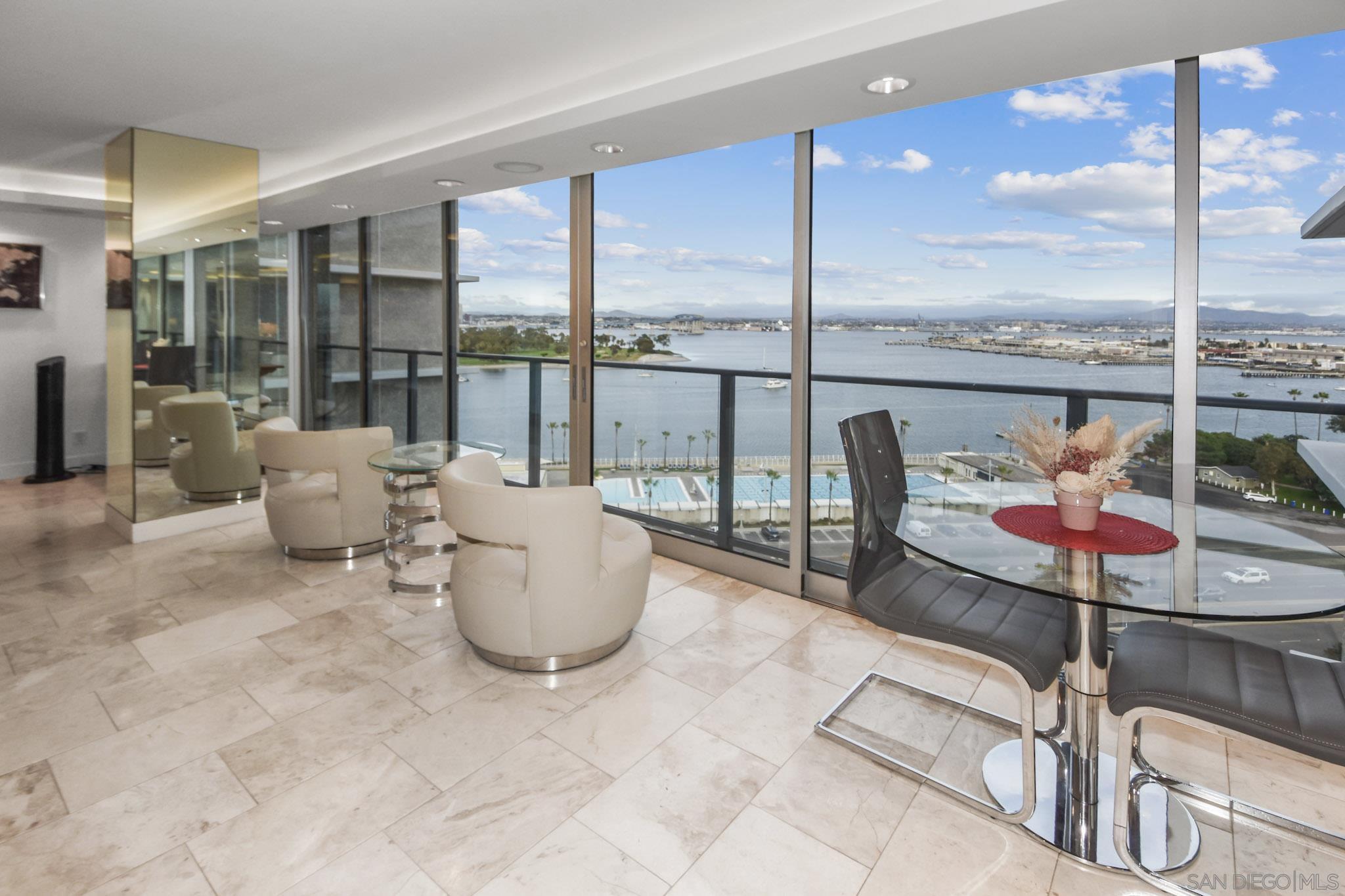 a living room with furniture and floor to ceiling window