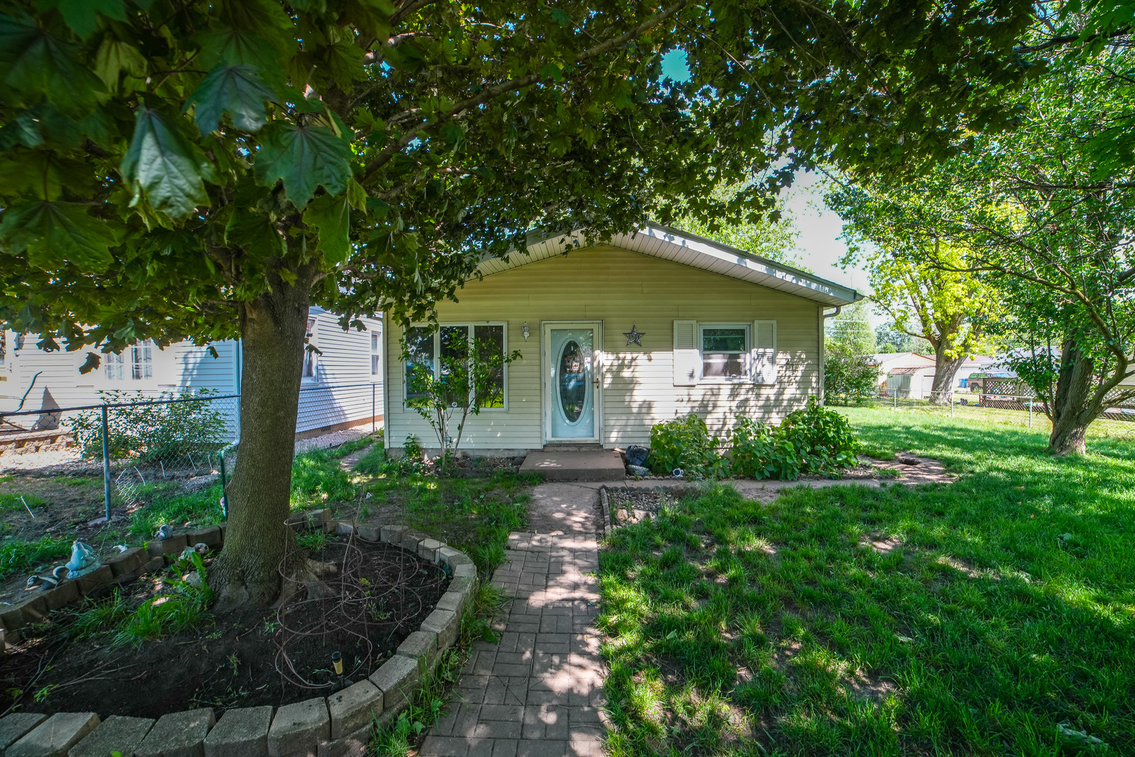 a front view of a house with garden